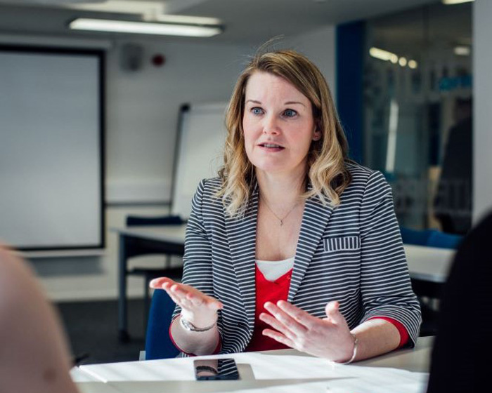 A staff member speaking in a meeting