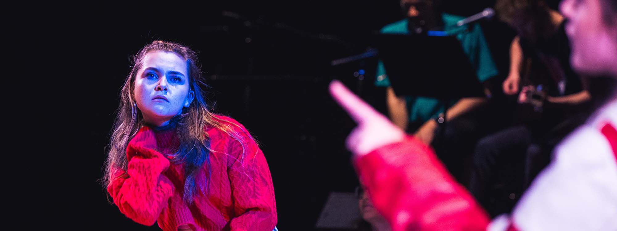 A woman poses as someone films her