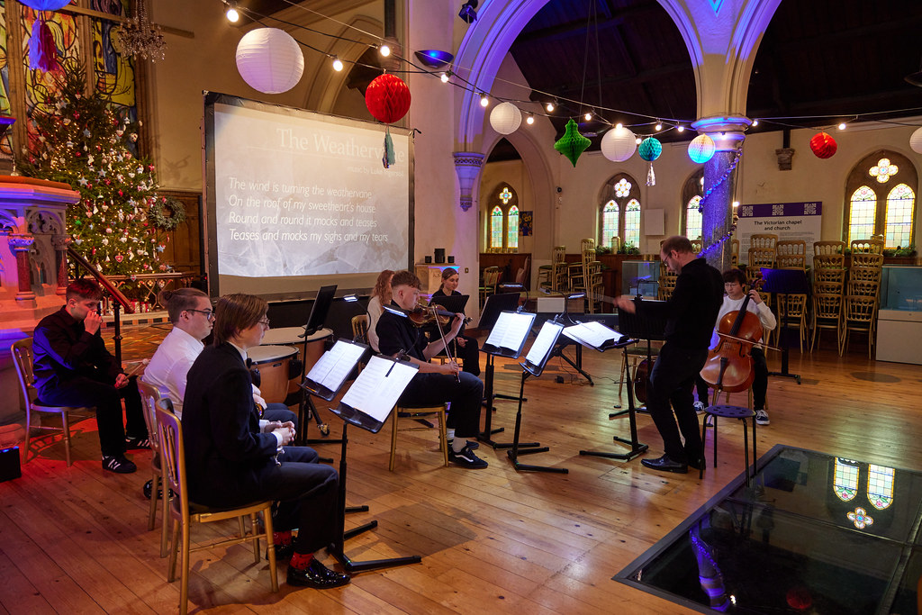 Students playing instruments in a church