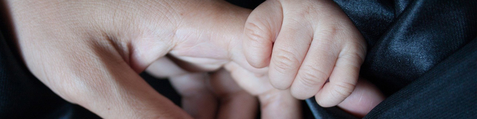 Baby holding a father's hand